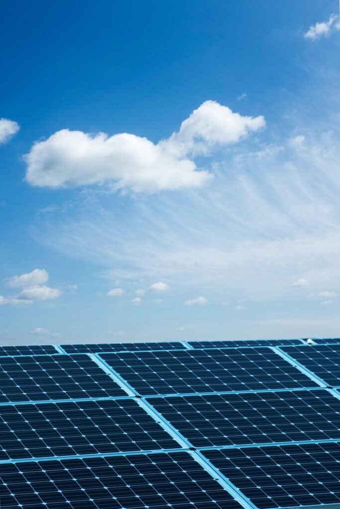 Solar panels under a clear blue sky, symbolizing renewable energy and sustainability.